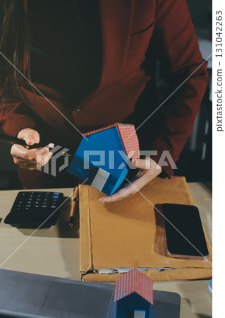 Customer signing a real estate contract in real estate agency. 131042263