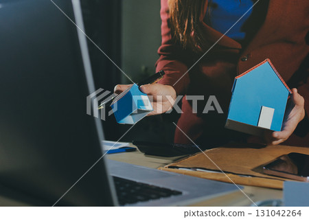 Customer signing a real estate contract in real estate agency. 131042264