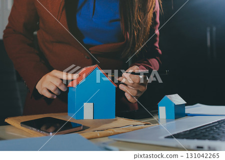 Customer signing a real estate contract in real estate agency. 131042265