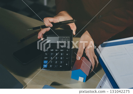 Customer signing a real estate contract in real estate agency. Customer signing a real estate contract in real estate agency. 131042275