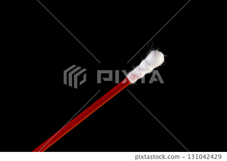 one stick with cotton for hygienic procedures, red sticks with natural white cotton at the ends for personal hygiene one stick with cotton for hygienic procedures, red sticks with natural white cotton at the ends for personal hygiene 131042429
