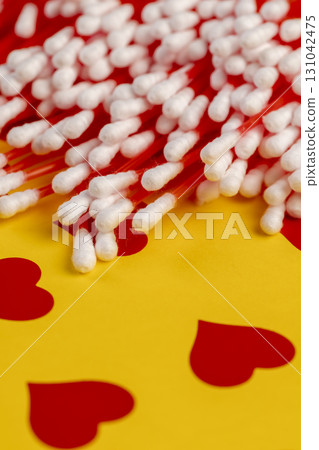 red sticks with white cotton for hygienic procedures, red sticks with natural white cotton at the ends for personal hygiene red sticks with white cotton for hygienic procedures, red sticks with natural white cotton at the ends for personal hygiene 131042475
