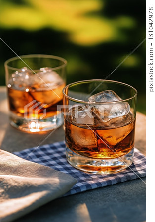 Refreshing Iced Drinks on a Sunny Table in a Cozy Outdoor Setting During Afternoon Relaxation Time. Refreshing Iced Drinks on a Sunny Table in a Cozy Outdoor Setting During Afternoon Relaxation Time. 131042978