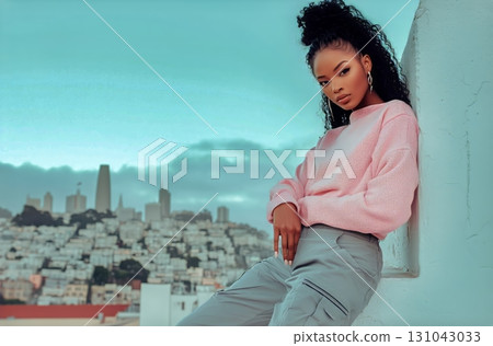 Young Woman Poses Against a City Skyline in San Francisco During a Cloudy Afternoon 131043033