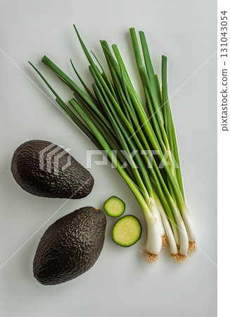 Fresh Green Onions, Avocado, and Cucumber Arranged on a Clean Surface. 131043054
