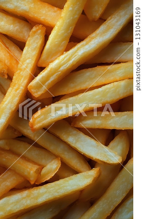 Crispy Golden French Fries Piled Together in a Delicious, Tempting Display at a Fast Food Restaurant 131043169