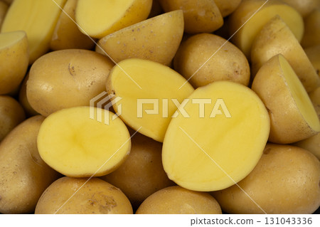 Fresh Raw Potatoes Cut In Half Close-Up Macro View. Fresh Raw Potatoes Cut In Half Close-Up Macro View. 131043336