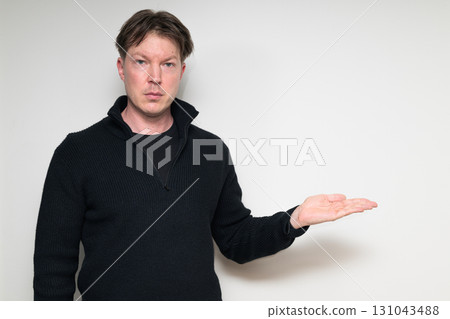 Portrait of Scandinavian mid adult man in black sweater against white background Portrait of Scandinavian mid adult man in black sweater against white background 131043488