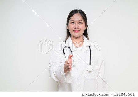 Portrait of Southeast Asian healthcare worker woman doctor in lab coat giving handshake Portrait of Southeast Asian healthcare worker woman doctor in lab coat giving handshake 131043501