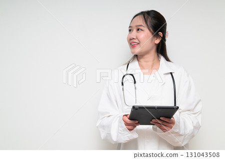 Portrait of young Asian healthcare worker woman doctor in lab coat using digital tablet computer Portrait of young Asian healthcare worker woman doctor in lab coat using digital tablet computer 131043508
