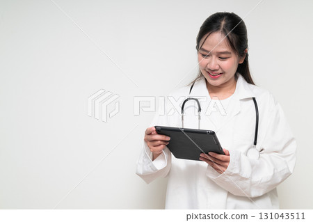 Portrait of young Asian healthcare worker woman doctor in lab coat using digital tablet computer Portrait of young Asian healthcare worker woman doctor in lab coat using digital tablet computer 131043511