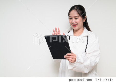 Portrait of young Asian healthcare worker woman doctor in lab coat using digital tablet computer Portrait of young Asian healthcare worker woman doctor in lab coat using digital tablet computer 131043512
