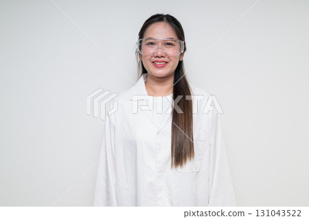Portrait of Asian healthcare worker scientist woman in lab coat wearing safety goggle glasses 131043522