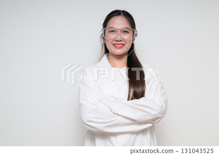 Portrait of Asian healthcare worker scientist woman in lab coat wearing safety goggle glasses 131043525