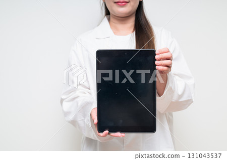 Digital tablet computer screen with copy space shown by doctor woman 131043537