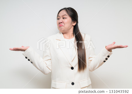 Portrait of young Asian woman wearing suit looking stressed and annoyed Portrait of young Asian woman wearing suit looking stressed and annoyed 131043592