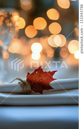 Elegant Table Setting With Autumn Leaf Centerpiece at a Cozy Gathering During Evening 131043786