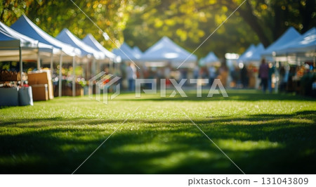 Vibrant Outdoor Market With Tents and Visitors Enjoying a Sunny Day in a Green Park Space 131043809