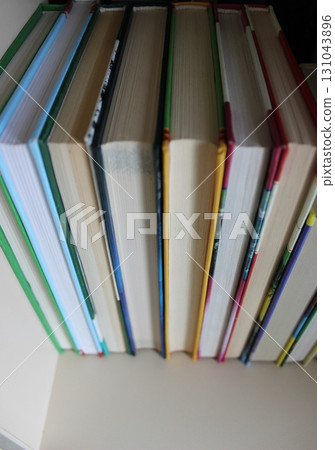 Books in a hard cover are arranged with a book block towards the viewer 131043896