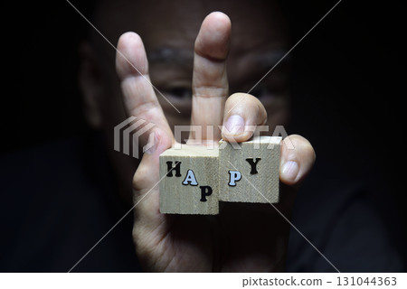 Old man holding HAPPY message Old man holding HAPPY message 131044363