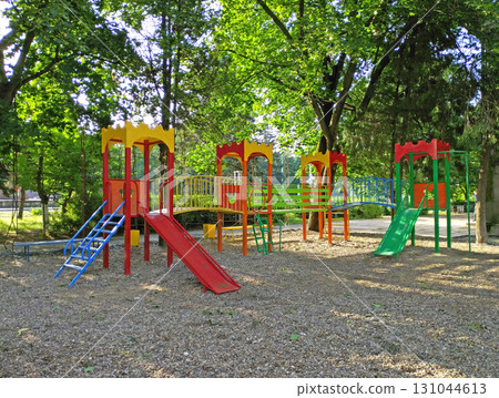 children's playground in the shade of the trees of a city park children's playground in the shade of the trees of a city park 131044613