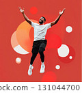 Energetic african american athlete jumping, arms raised, exuding joy against vibrant red studio backdrop with geometric shapes 131044700