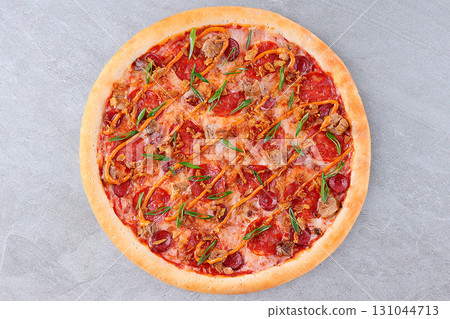 Delicious Meat Pizza with Pepperoni, Bacon, Sausage, Green Onions, and Crispy Onions on Tomato Sauce and Melted Cheese 131044713