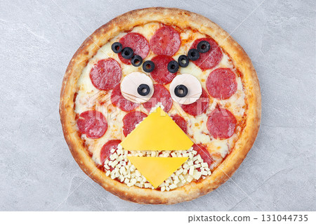 Creative Angry Birds Style Pepperoni Pizza Decorated with Cheese Beak, Ham Eyes, and Olive Details on Gray Stone Background Creative Angry Birds Style Pepperoni Pizza Decorated with Cheese Beak, Ham Eyes, and Olive Details on Gray Stone Background 131044735