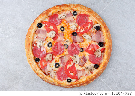 Pizza with Bacon, Pepperoni, Mushrooms, Tomato Slices, Black Olives and Melted Cheese on Stone Background 131044758