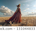 Boho-chic woman in flowing patterned dress with floral crown standing in wild grass field. Ideal for festival fashion, ethereal weddings, and dreamy lifestyle content 131044833