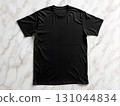 Black cotton t-shirt displayed flat on pristine marble surface. Perfect for e-commerce product shots, minimalist fashion catalogs, and basic apparel promotions 131044834