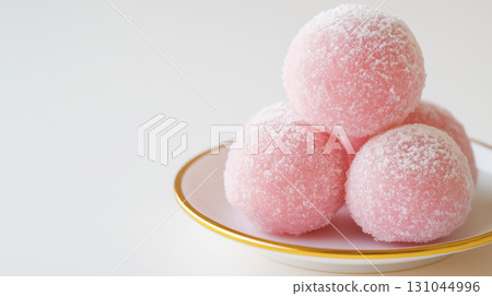 Delicate pink mochi dusted with fine powdered sugar 131044996
