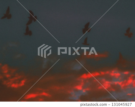 Birds flying against a fiery sunset sky. Silhouetted birds soar across a dramatic sky ablaze with fiery red and orange hues Birds flying against a fiery sunset sky. Silhouetted birds soar across a dramatic sky ablaze with fiery red and orange hues 131045927