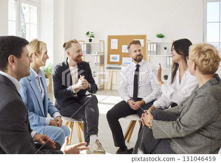 Professionals sitting in circle in office, discussing ideas, enjoying teamwork and collaboration. Professionals sitting in circle in office, discussing ideas, enjoying teamwork and collaboration. 131046459