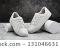 Pair of men's casual white shoes on marble background 131046631