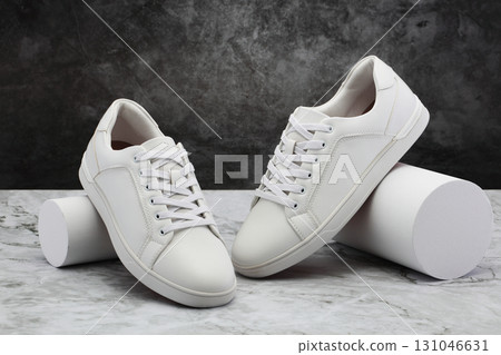 Pair of men's casual white shoes on marble background Pair of men's casual white shoes on marble background 131046631