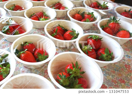 Fresh strawberries portioned into paper cups Fresh strawberries portioned into paper cups 131047553