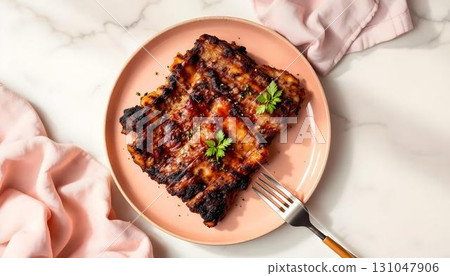 A plate featuring Memphis Baby Back Ribs alongside perfectly cooked eggs, embodying summer flavors 131047906