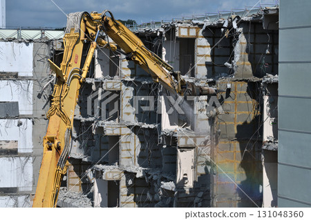 Aged public housing to be demolished Work scene of dismantling with large heavy machinery Aged public housing to be demolished Work scene of dismantling with large heavy machinery 131048360