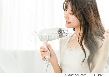 女人用吹風機吹乾頭髮（護髮） 131049239