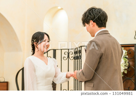 Bride and groom exchanging rings at the wedding hall (wedding ring, marriage ring, wedding, bridal) 131049981