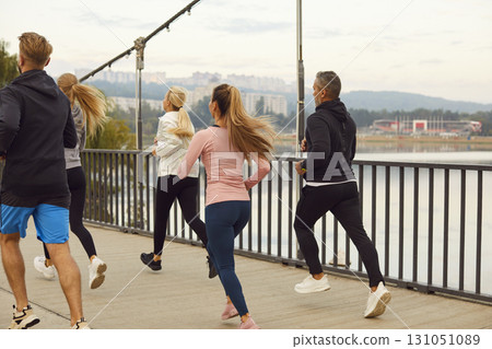 Team Of Athletes Running Together In City Park 131051089
