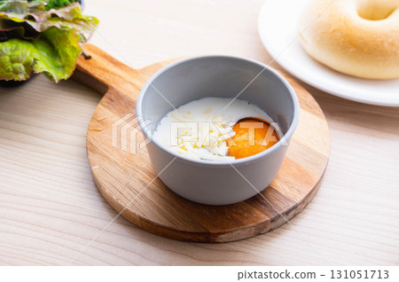 Add milk to salted raw eggs and cheese 131051713