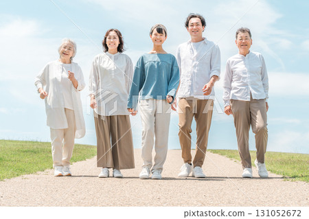 Happy family walking on a hill with a road, family, parent and child, three generation family 131052672