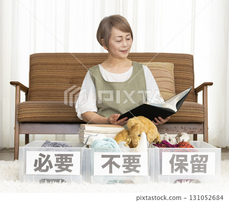 Senior woman decluttering in the living room Senior woman decluttering in the living room 131052684
