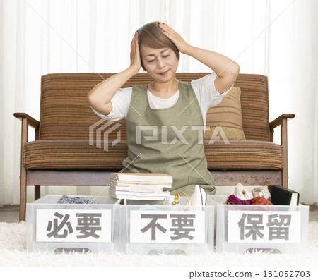 Senior woman decluttering in the living room Senior woman decluttering in the living room 131052703