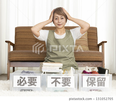 Senior woman decluttering in the living room Senior woman decluttering in the living room 131052705