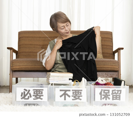 Senior woman decluttering in the living room Senior woman decluttering in the living room 131052709