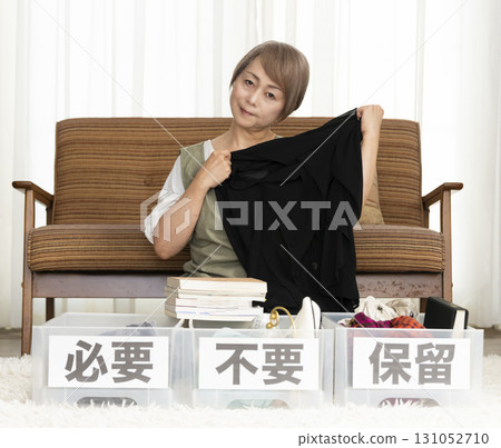 Senior woman decluttering in the living room Senior woman decluttering in the living room 131052710