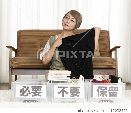 Senior woman decluttering in the living room Senior woman decluttering in the living room 131052711